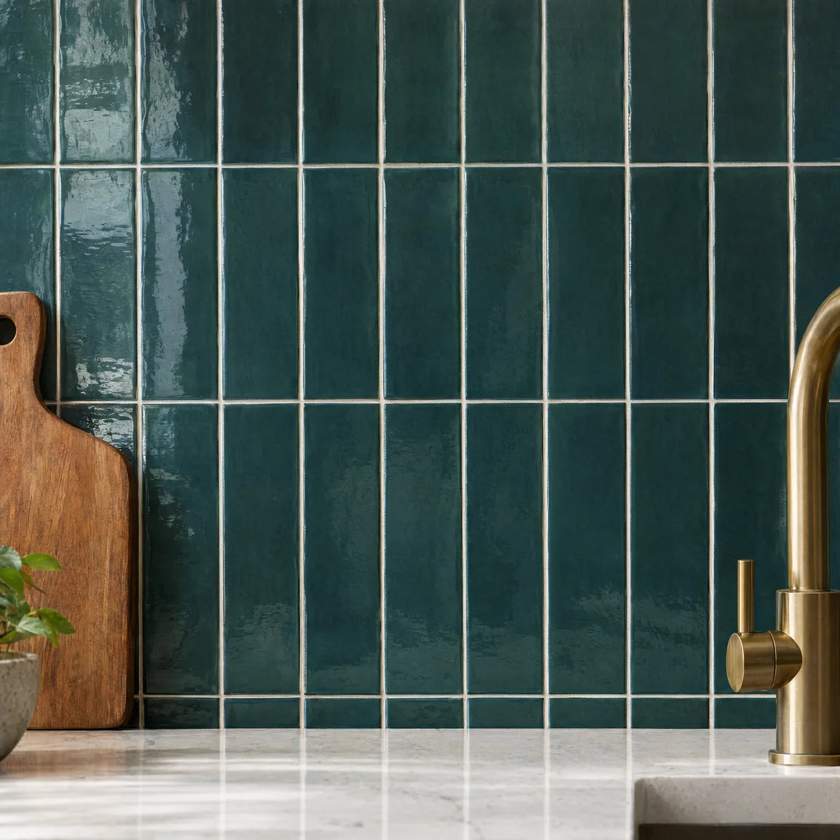 Teal ceramic tile backsplash with a brass faucet detail
