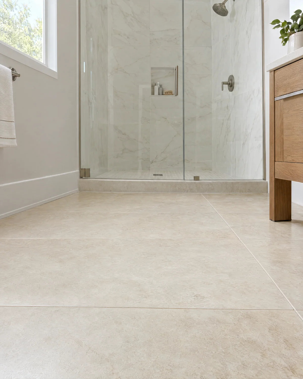 Ivory porcelain floor and wall tile in a bright bathroom